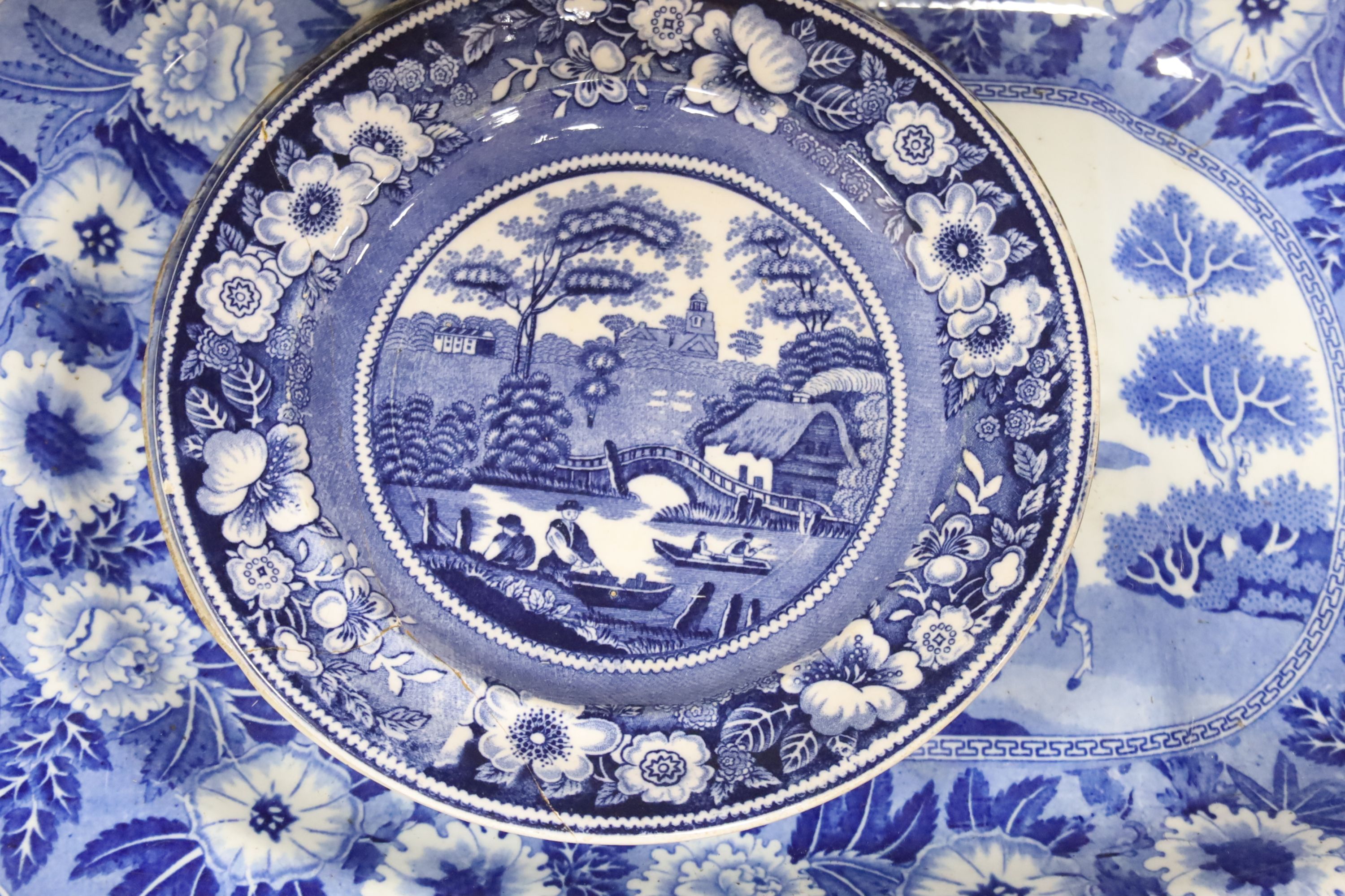 A late 19th century blue and white pottery meat dish, width 50cm, two plates and a Chinese style dish